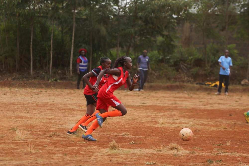 Young athletes playing football together