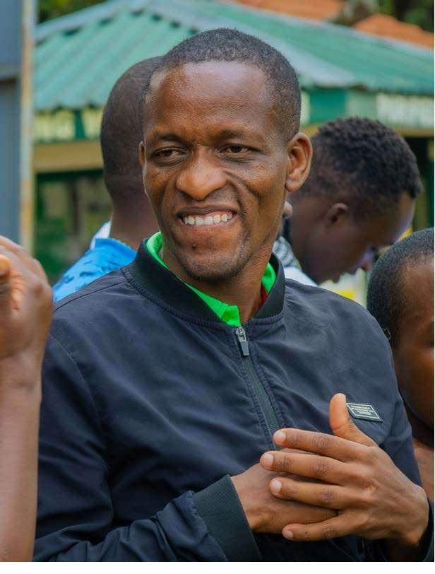 Kelvin Kyalo smiling among colleagues